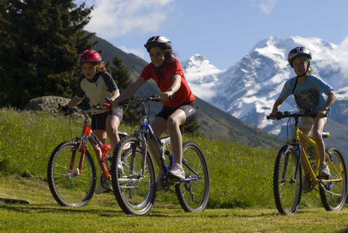 Children on mountain bikes at the foot of Monte Rosa